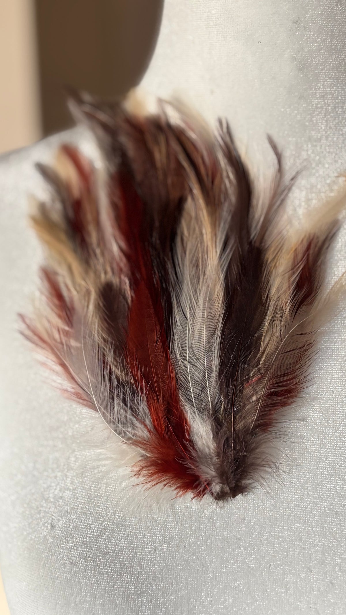 Garbo Brick, Brown & Ivory feather pin and clip close-up on dress form