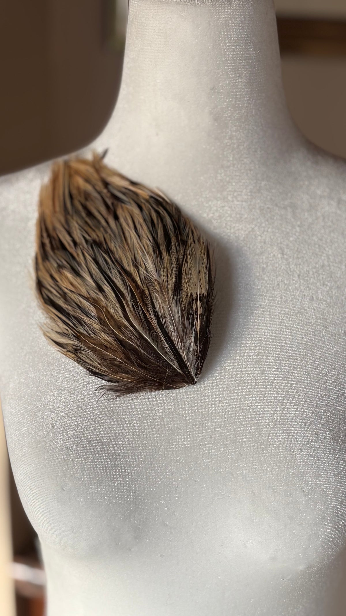 Garbo Ivory & Brown feather pin and clip pinned on dress form