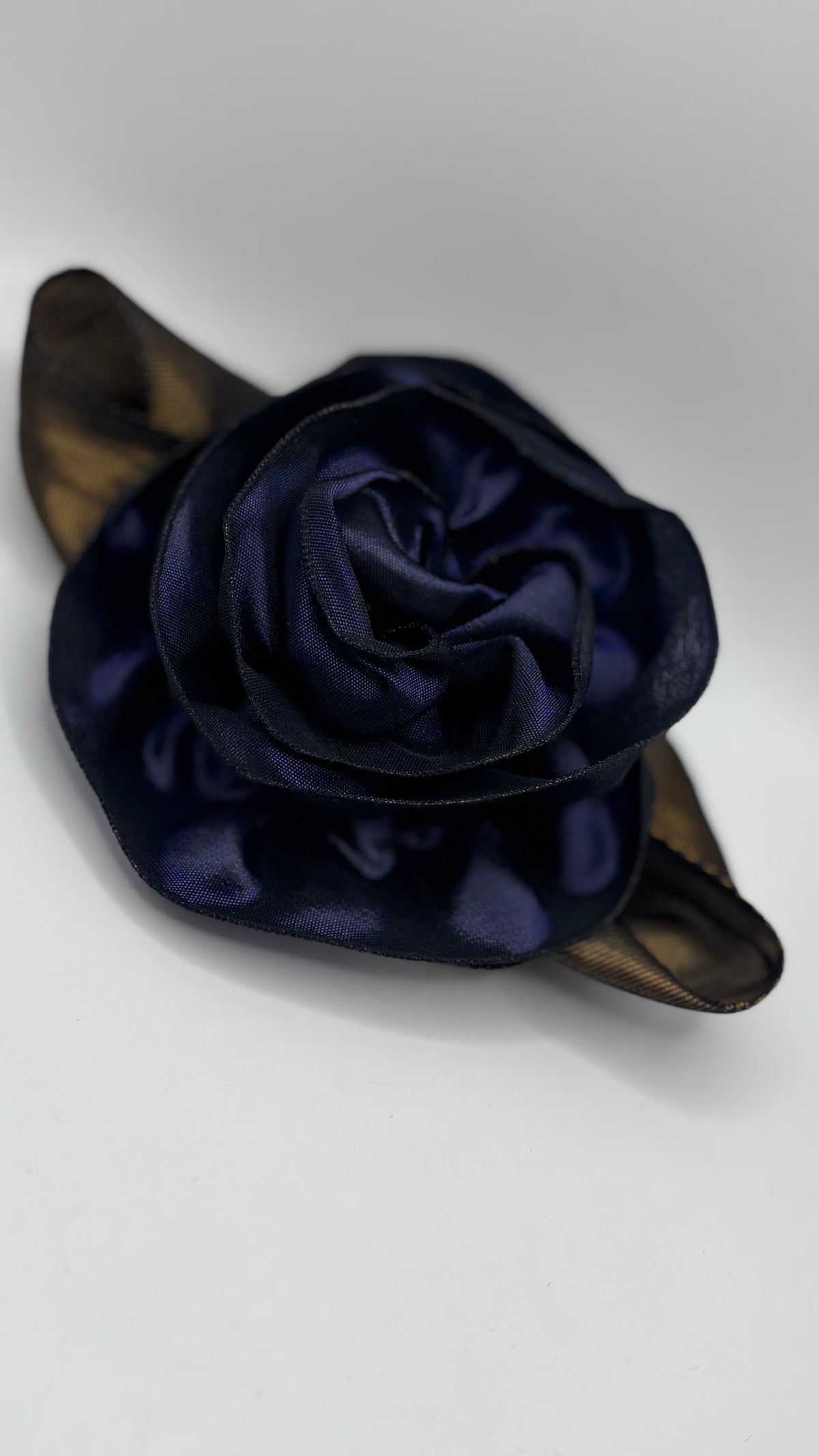 “Rosette” Brooch & Clip in Purple.  Pin or Clip to dresses, lapels, purse, hat or wear as a boutonniere. Made in the USA.  You can reshape the flower and leaves to make it larger or smaller.
