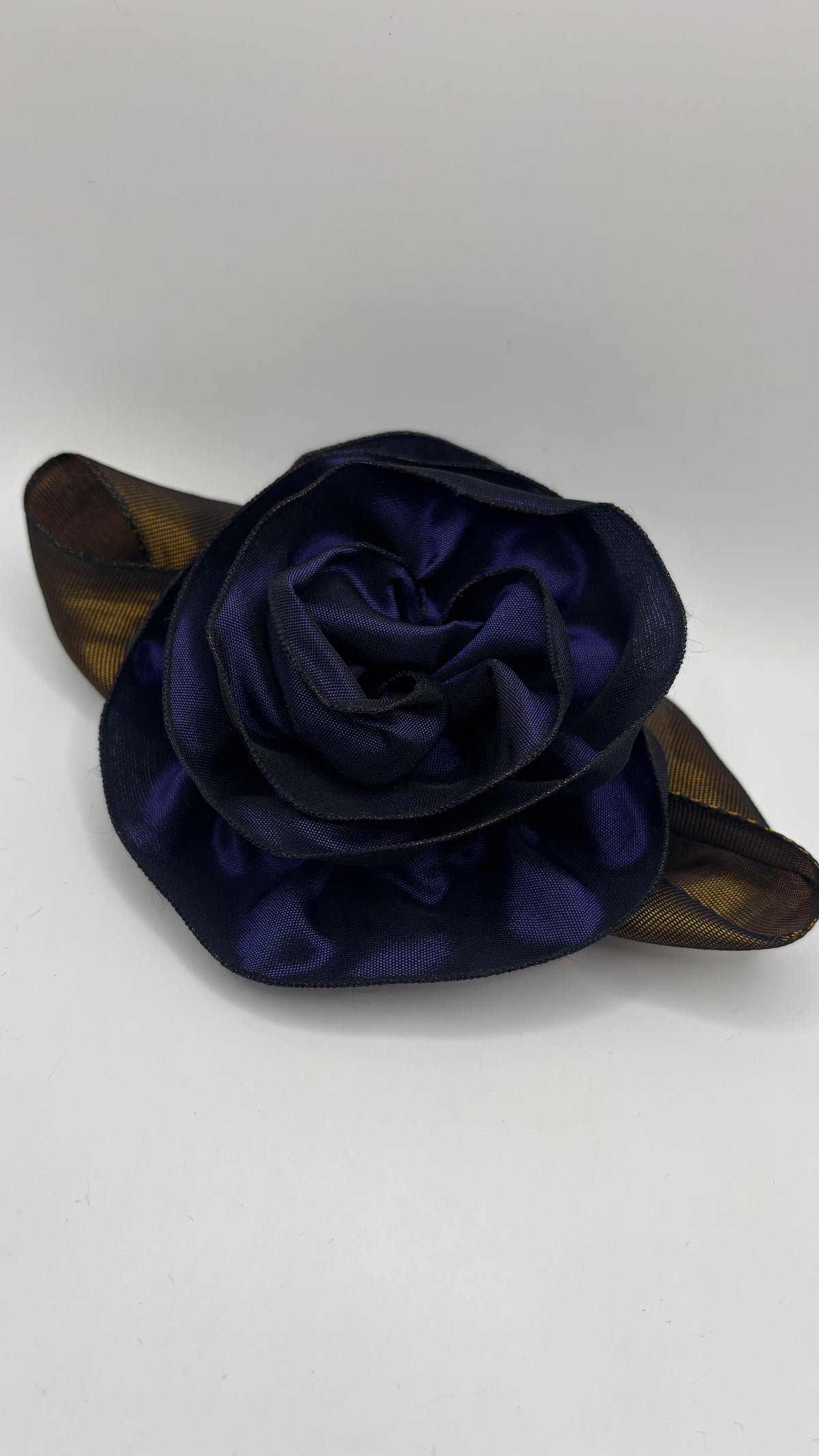 “Rosette” Brooch & Clip in Purple.  Pin or Clip to dresses, lapels, purse, hat or wear as a boutonniere. Made in the USA.  You can reshape the flower and leaves to make it larger or smaller.