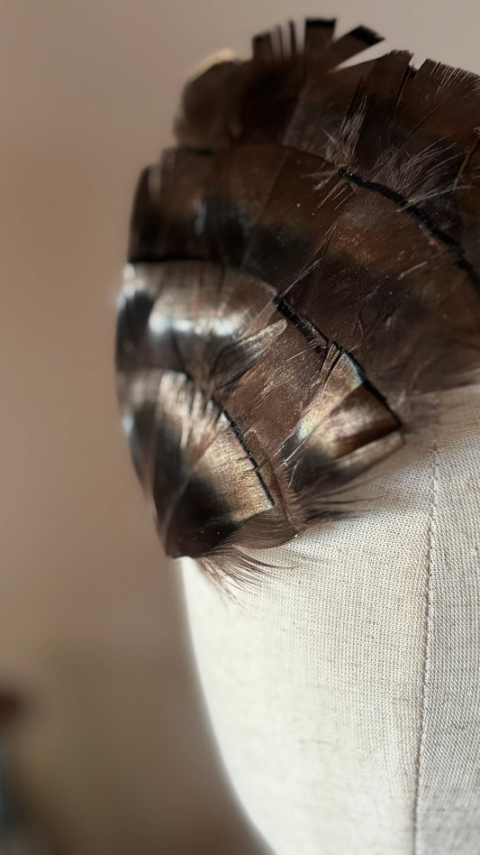 Garbo Iridescent Bronze & Black feather pin and clip on linen head form